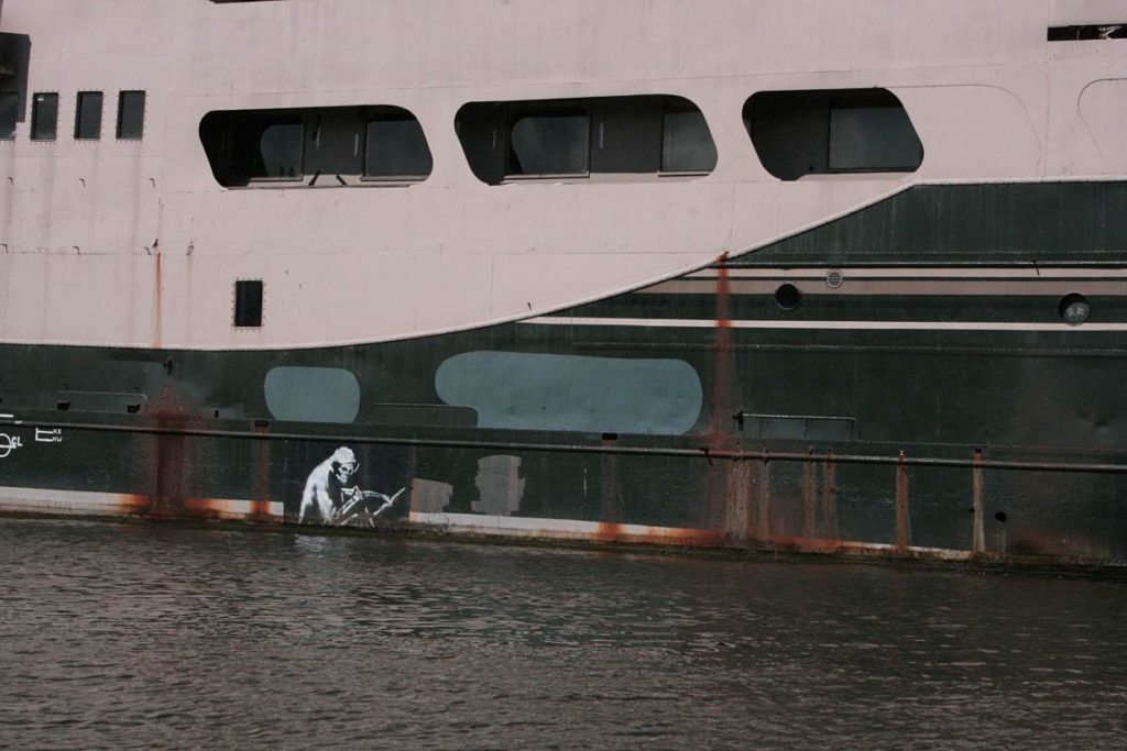 Banksy art on a boat on the Avon River in Bristol, England. How to spend a day in Bristol, England. This Splendid Shambles. 