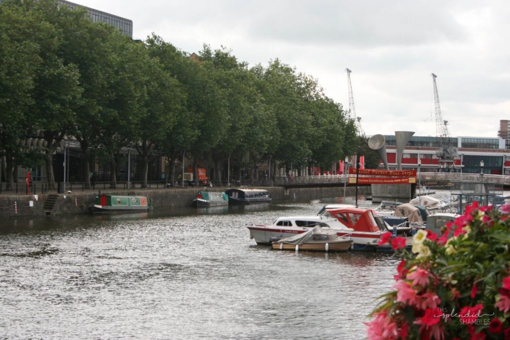 Boats on a river with trees lining the banks of the opposite side. How to spend a day in Bristol, England. This Splendid Shambles.