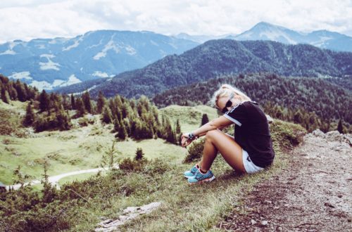 Woman sitting on a hiking trail. 6 things to do after university.
