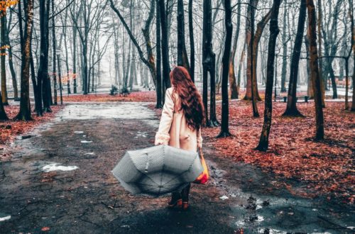 Woman with an umbrella walking away from the camera. 11-Reasons-a-Rainy-Day-is-Amazing