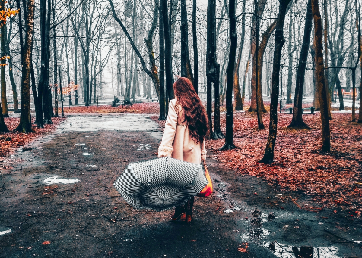 Woman with an umbrella walking away from the camera. 11-Reasons-a-Rainy-Day-is-Amazing