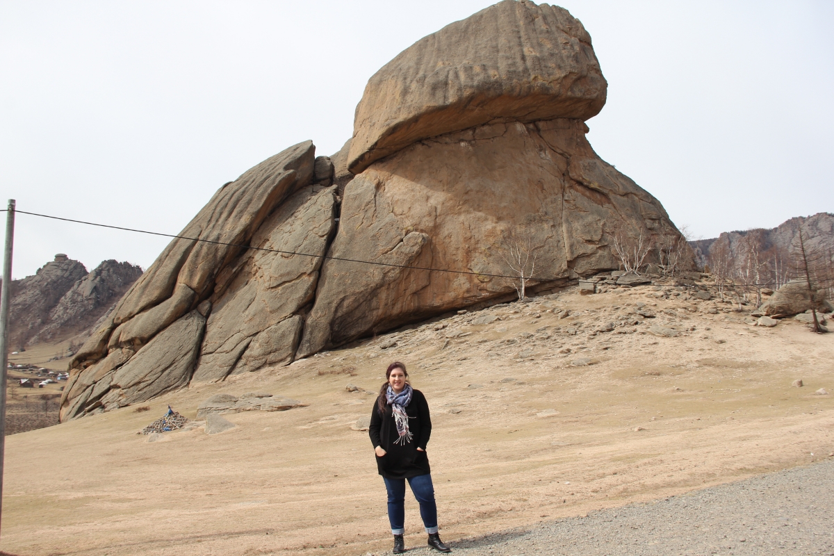 Anjali standing in front of Turtle Rock at Close up of Terelj National Park, Mongolia