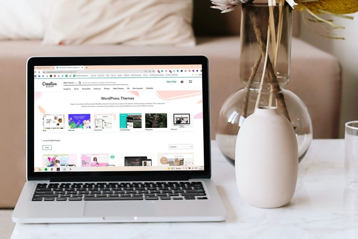 Creative Market screenshot on a laptop sitting on a coffee table. How to start a WordPress blog with Lyrical Host. This Splendid Shambles.