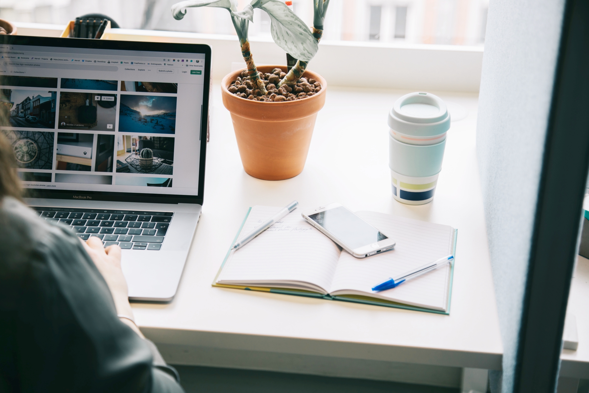 How to repurpose your blog content for vlog. Woman at a computer desktop with notebook and coffee