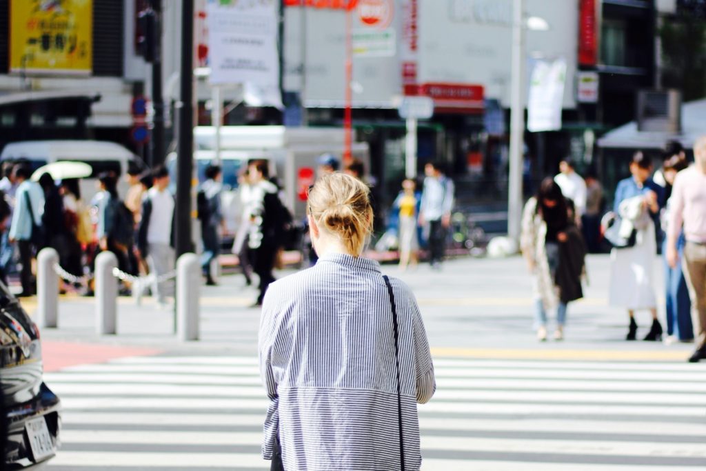 Woman facing away from the camera, at a crossing in Tokyo. This Splendid Shambles blog.