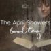 Woman sitting behind a window with rain drops on it, reading a book. The April Showers Book Tag on This Splendid Shambles