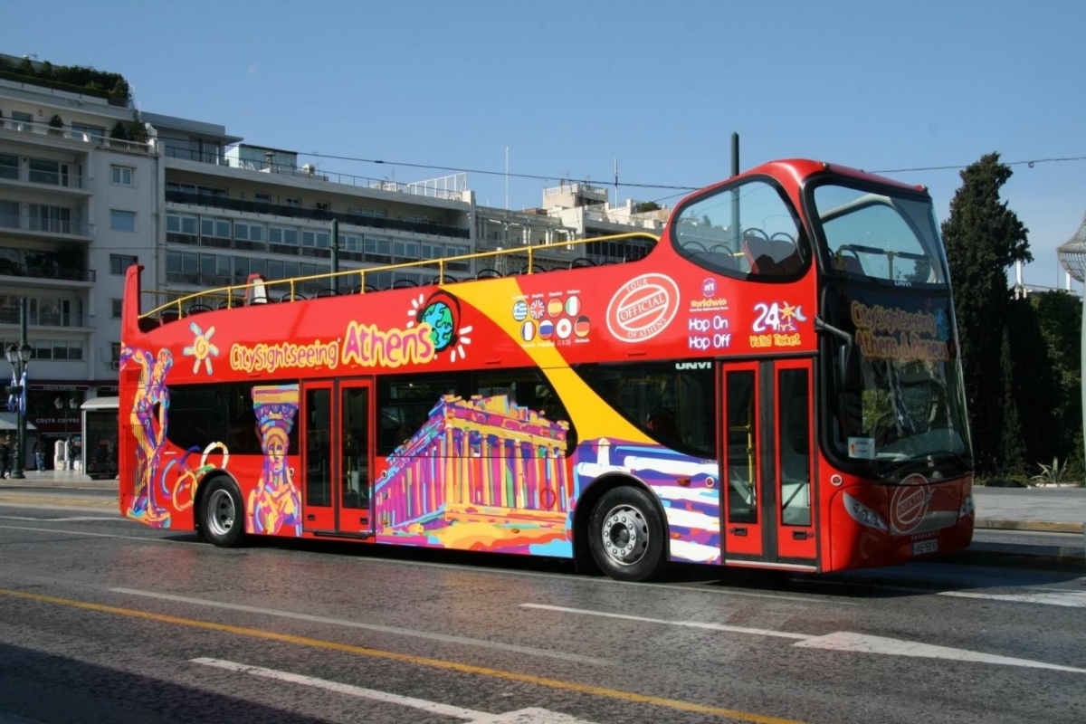 Hop On Hop Off Bus Athens, driving down a street. Travelling to Greece on a Budget on This Splendid Shambles. 
