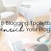 Woman with tattoos sitting at a desk sipping a hot drink, her knee up, her hand poised over a laptop on the desk. 8 Blogging Tools to Enrich Your Blog.