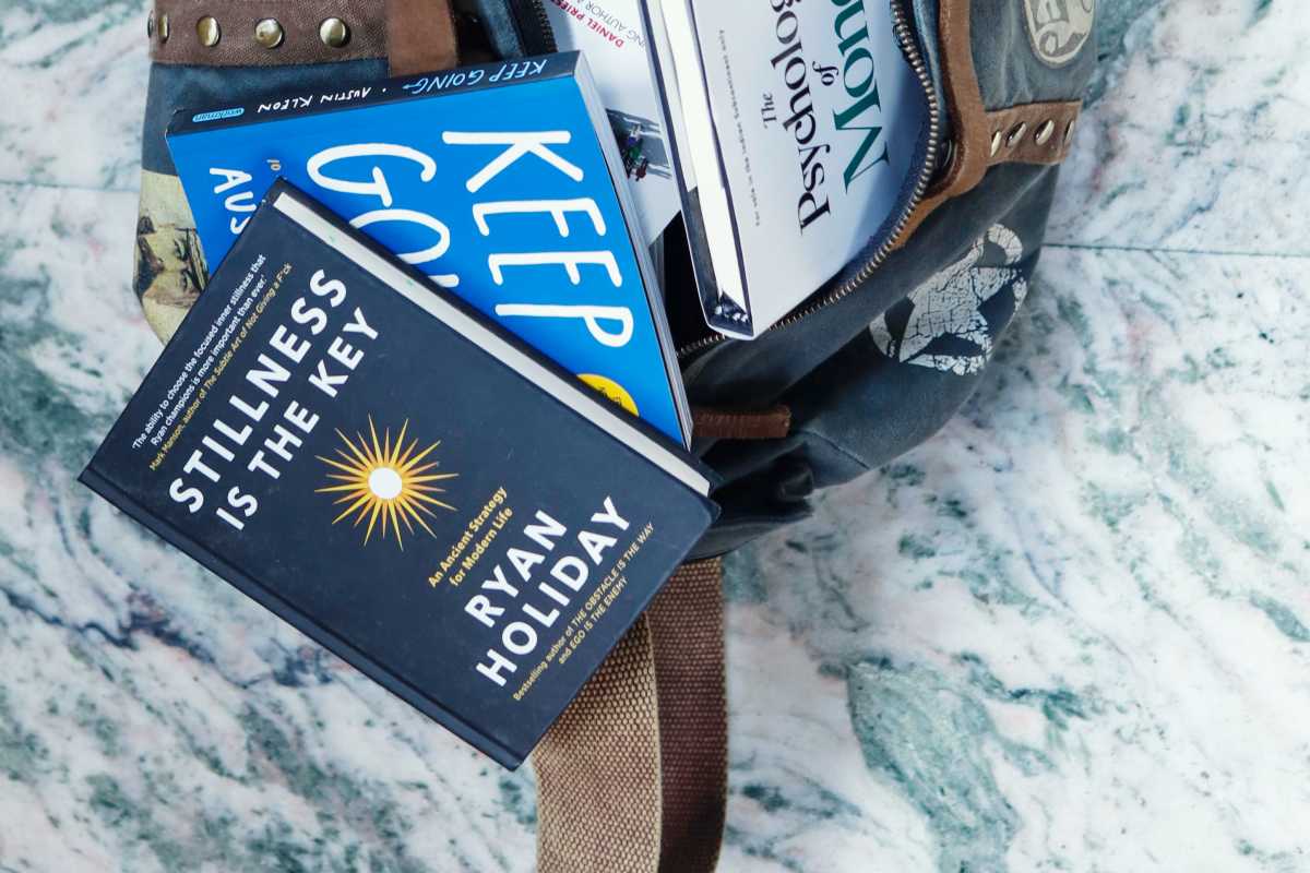 A bag with books spilling out of it. 