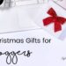 White table with a white laptop and white presents with red bows. 'Christmas gifts for bloggers' written on the left in black.