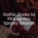 Dark image of an old book with a red rose on top, with a candelabra in the far right background. 'Gothic Books to pick up this spooky season' written in while on top.
