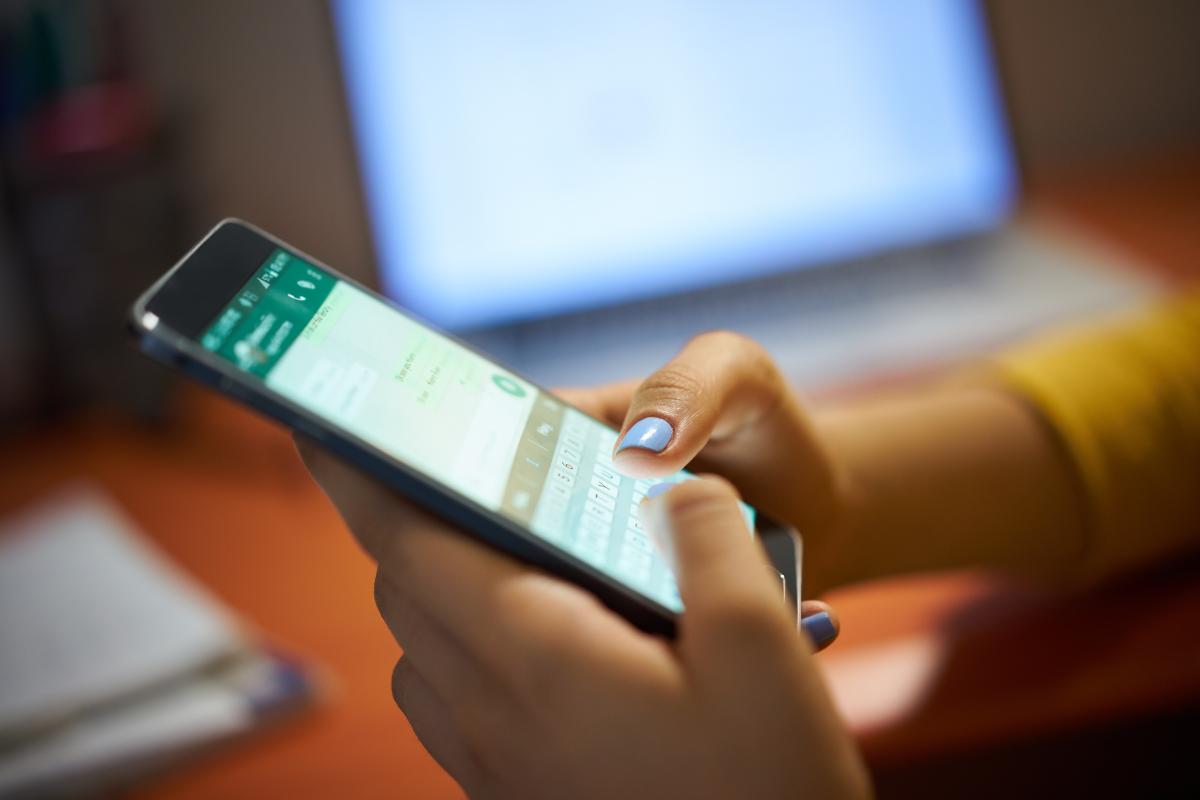 Hands of a woman using Whatsapp