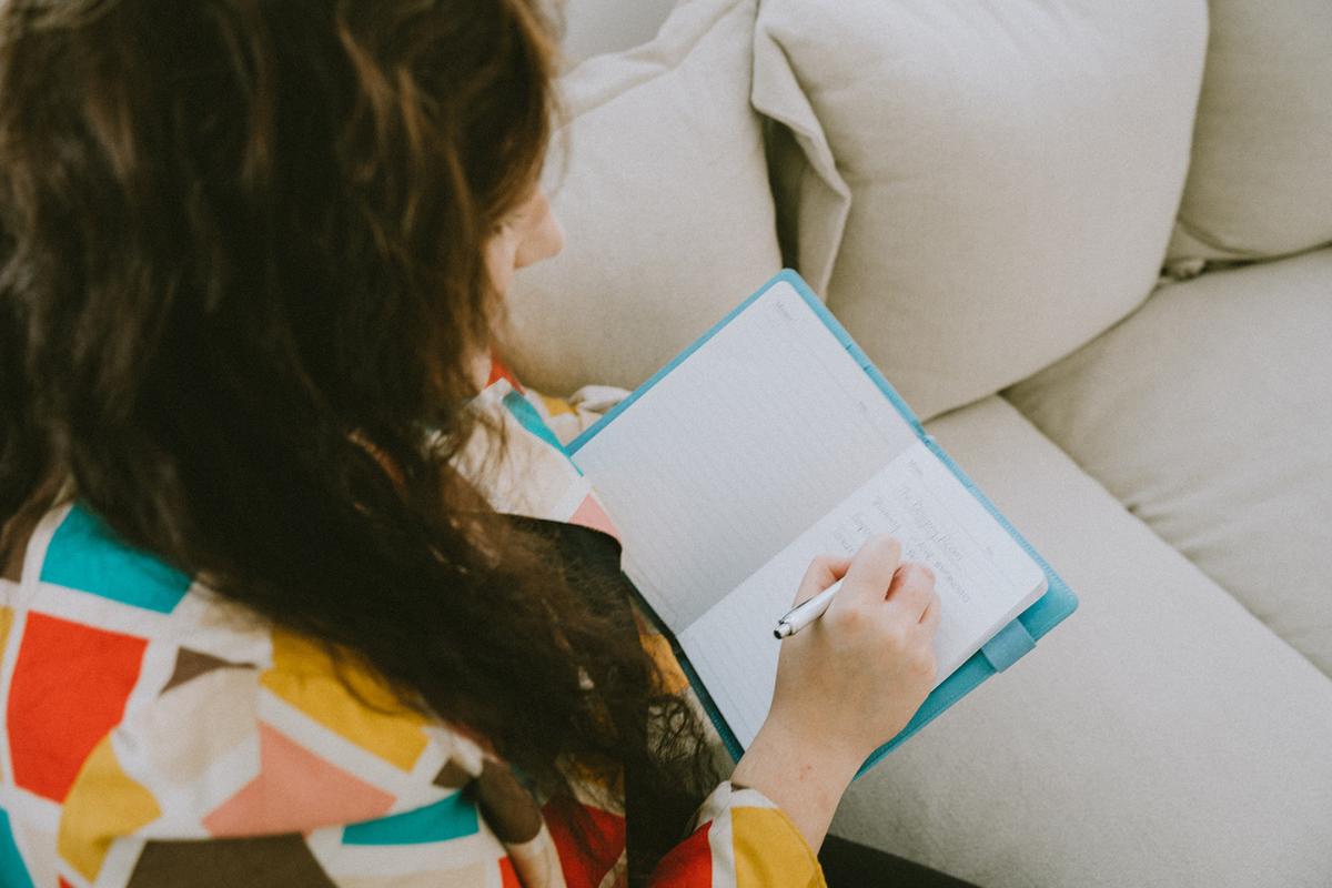 Anjali at This Splendid Shambles writing in a notebook.