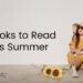 Anjali from This Splendid Shambles sitting outside, back up against a wall. She's wearing a yellow dress and a sunhat, and is holding a book. There are sunflowers by her on the ground. 'Books to read this Summer's is written in black to the left, overlayed.
