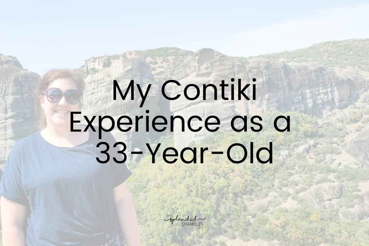 Woman in a blue tshirt and sunglasses standing at Meteora Monasteries in Greece, the words 'My Contiki Experience as a 33-Year-Old' written on top of the low opacity image.
